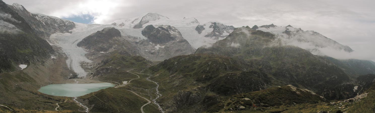 Mountains covered in snow, a gletscher and a narrow road