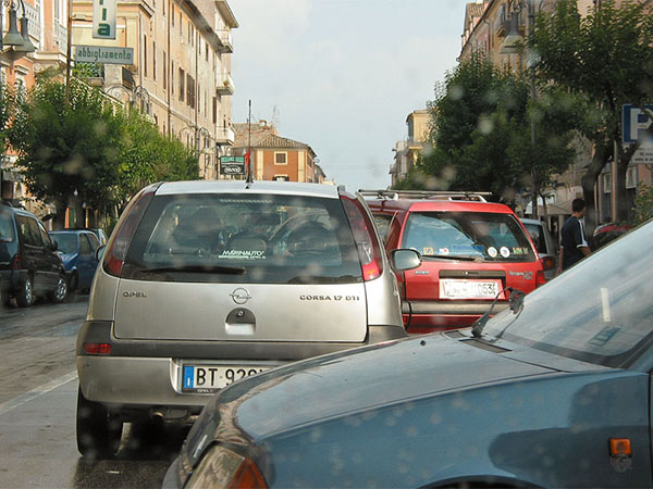 Cars criss cross in the street