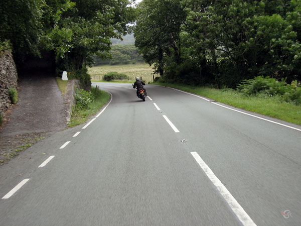 Entering a corner to the left, riding at the left side of the road